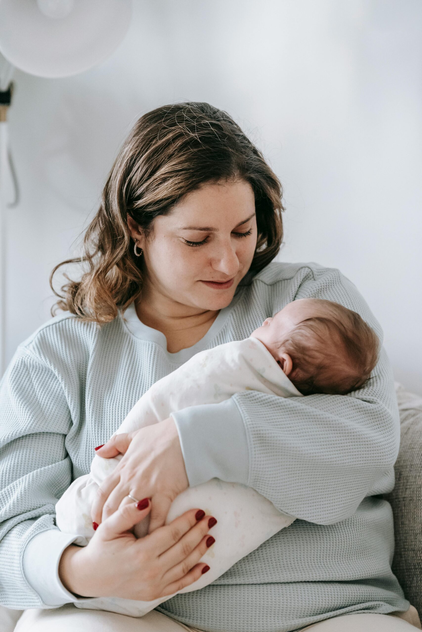 Mother holding newborn at home